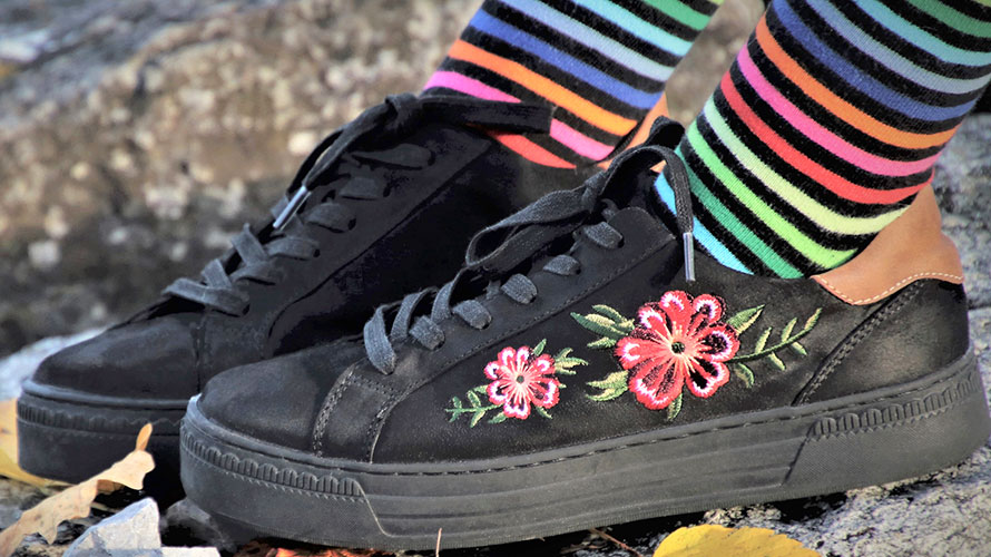 Bunte Ringelsocken und Sneaker mit Blümchenmotiv