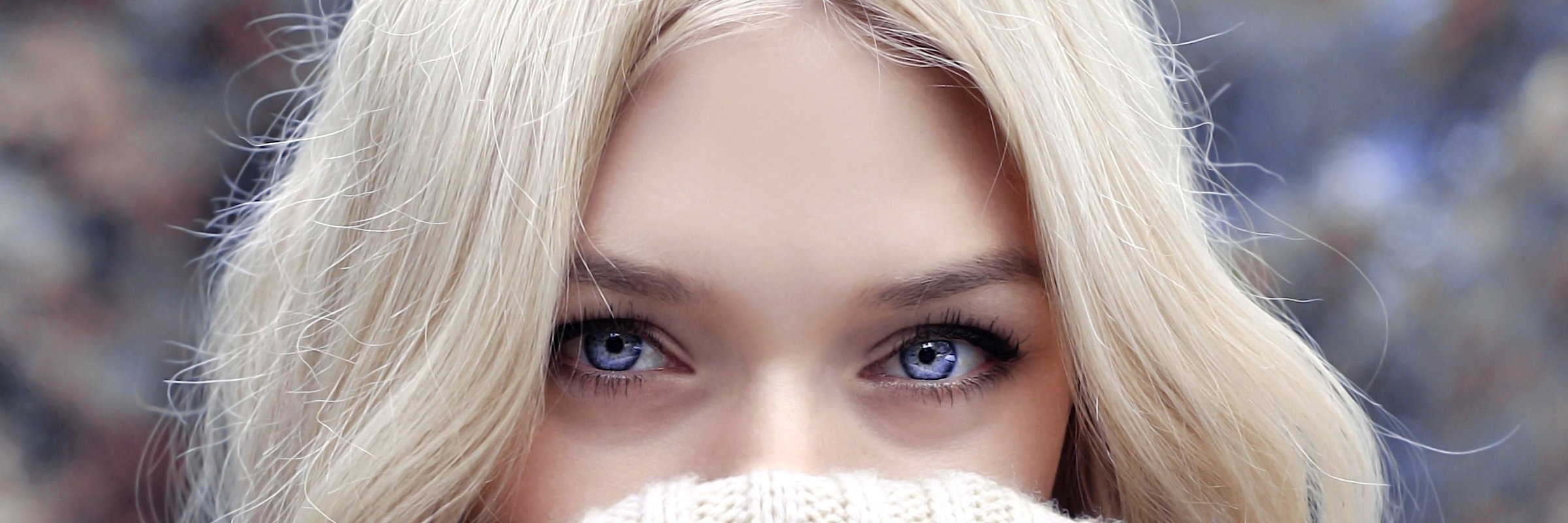 Close-up: Blonde Frau mit blauen Augen.